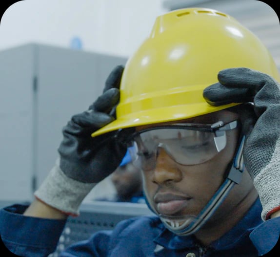 Gas Tech technician fitting a hard hat and safety glasses
