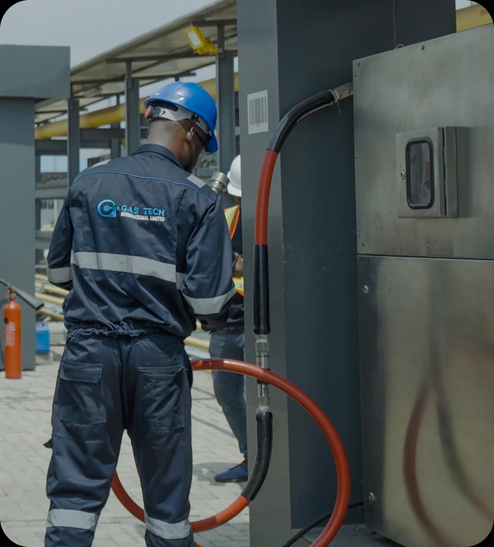Gas Tech technician connecting a CNG dispenser hose