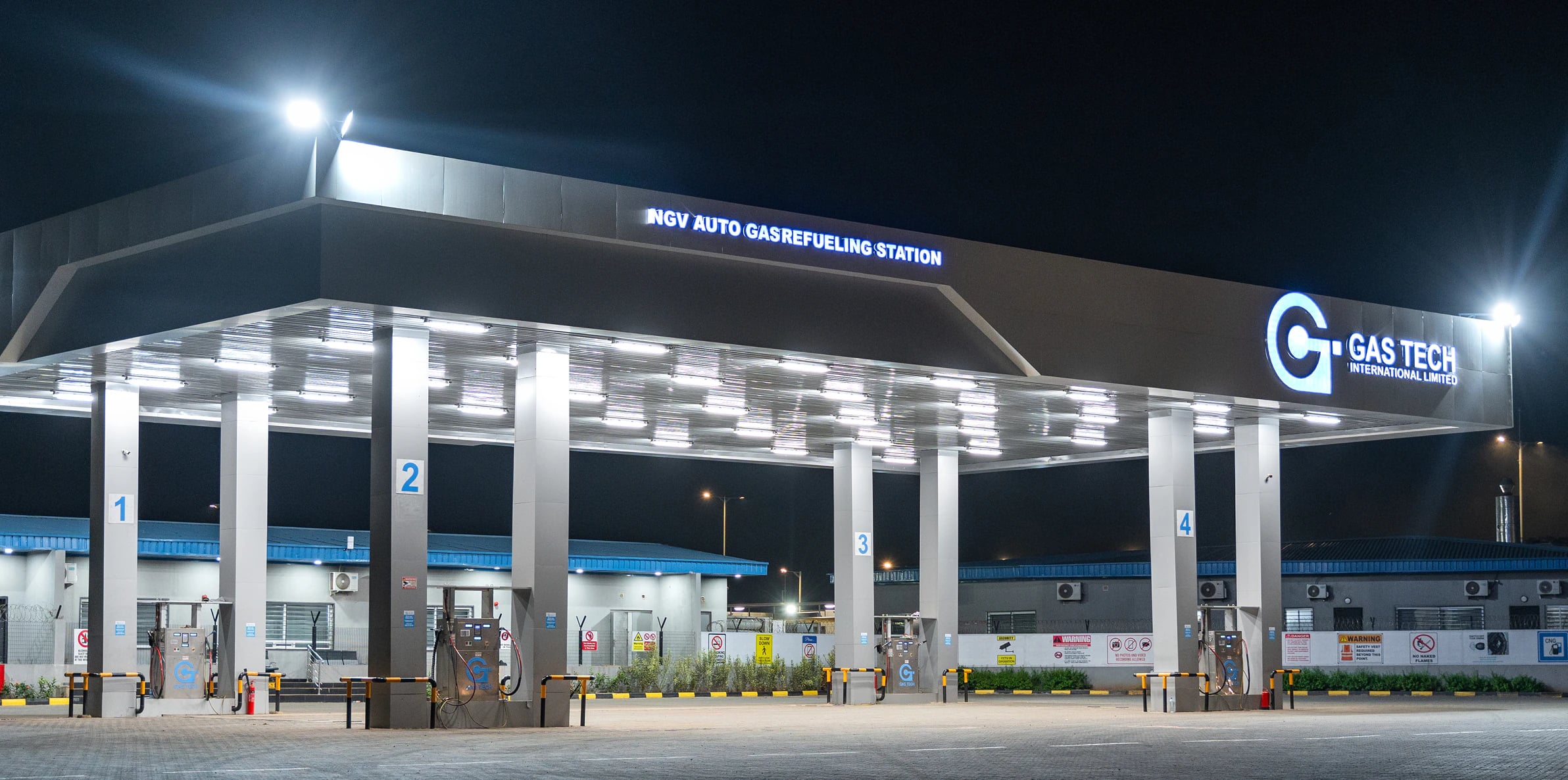The Gas Tech NGV Filling Station canopy lit up at night