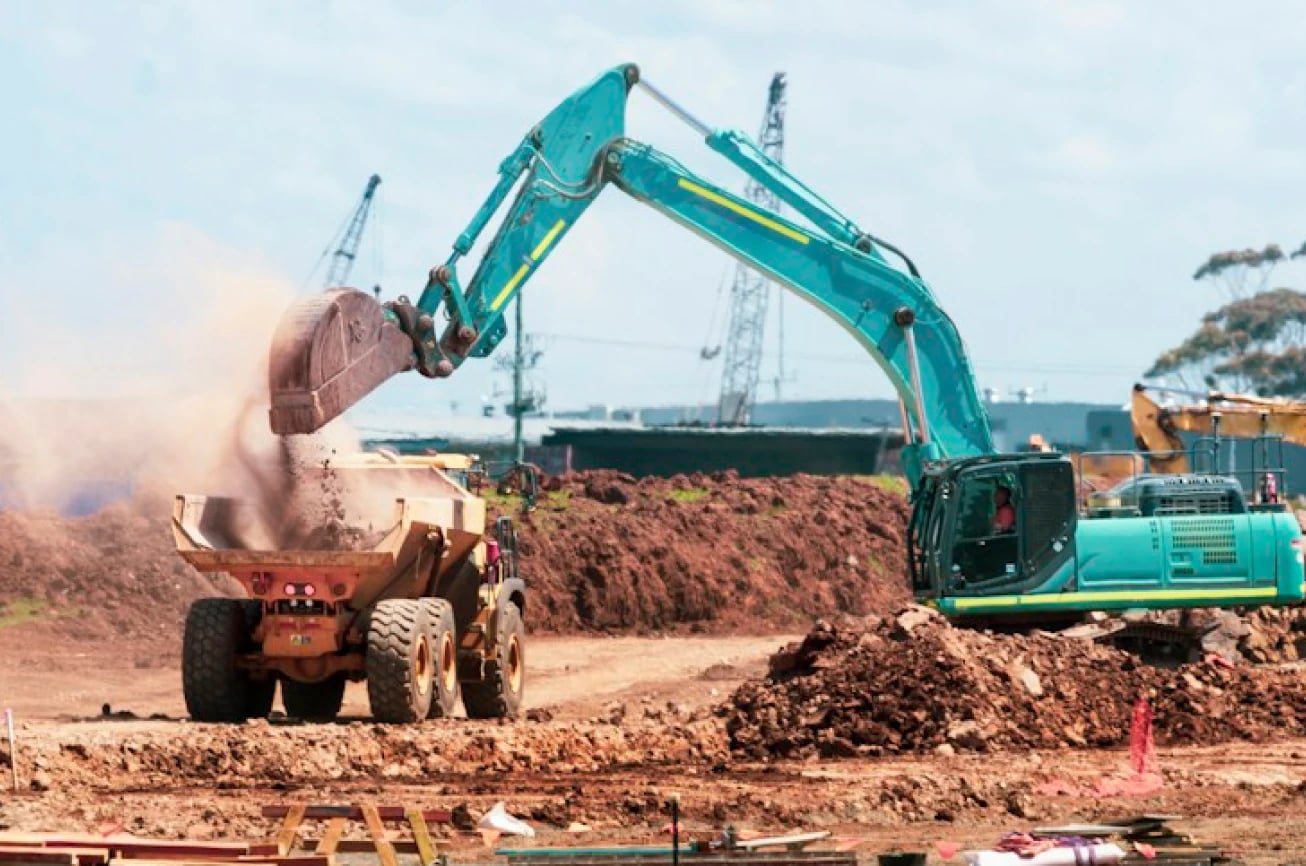 Excavator loading earth into a dump truck during the Sagamu expansion groundwork